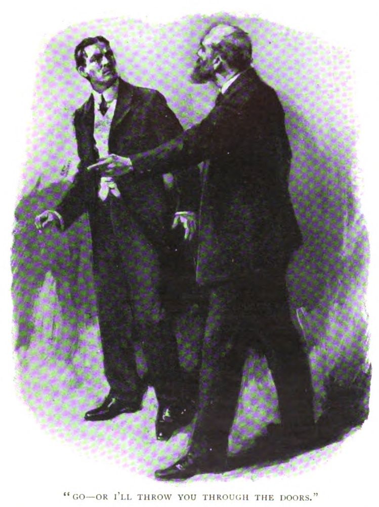 A bearded man faces a younger man in a threatening attitude, pointing with his left hand in a direction indicating the younger man should get out.
