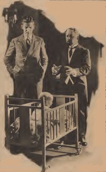 Dr. Martinus and Branscome look down at a child in a crib.